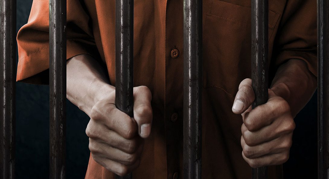man behind prison bars