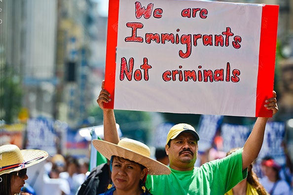 man holding sign at rally