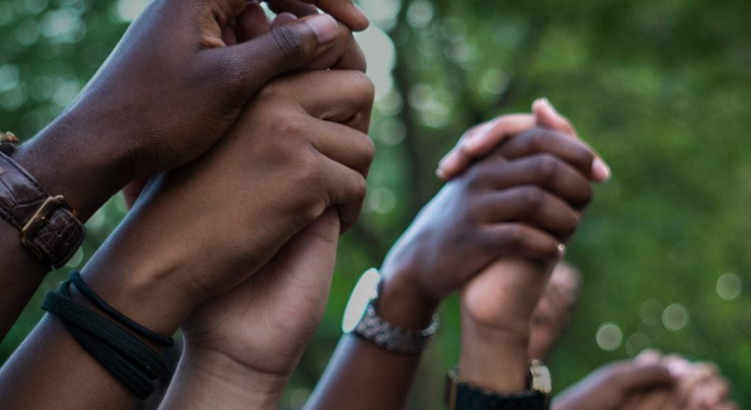 people holding hands in unity