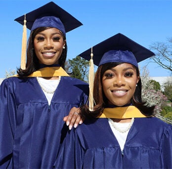 Identical twins graduating from JACSW 